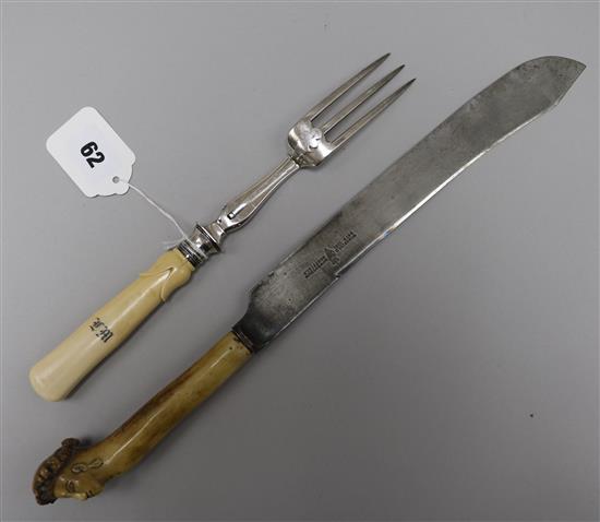 An early 19th century French silver carving fork and a later steel carving knife.